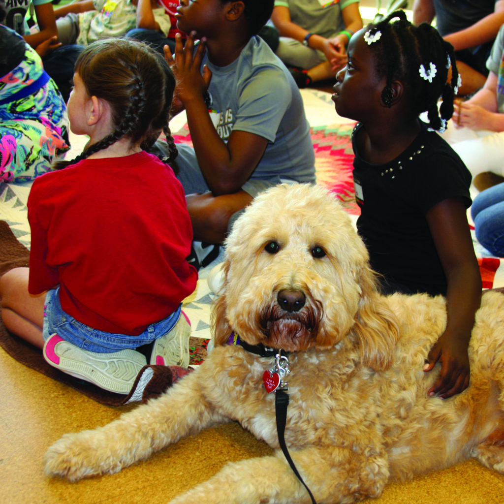 Therapy dog Howie Privett is always happy to get hugs at Arkansas's Art for the Heart grief workshops, which are part of the organization's Hope & Healing 4 Kids program.